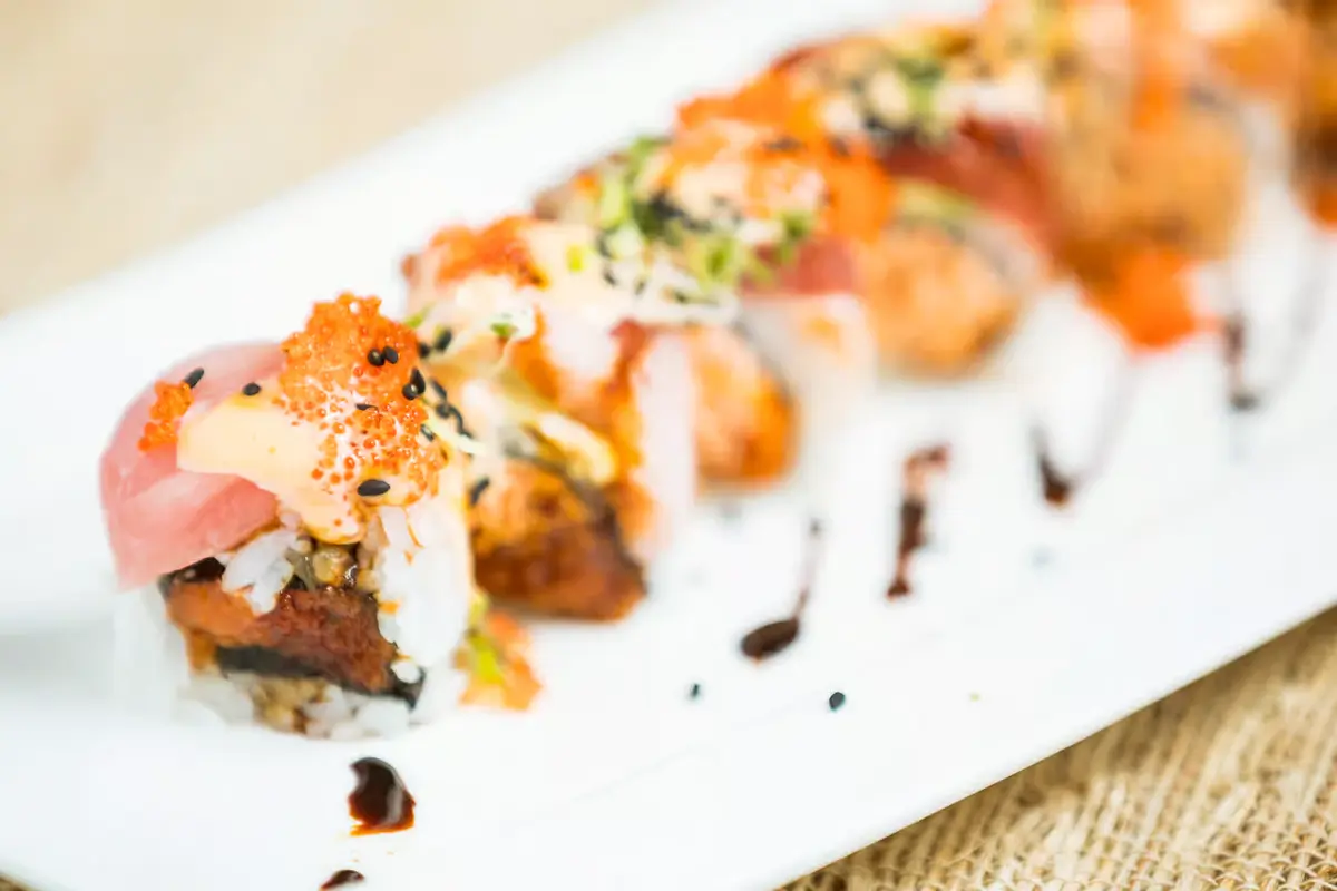 Sushi roll with fresh ingredients, sauce, tobiko, sesame, balsamic drizzle at Senro Sushi, a Sushi restaurant in San Ramon
