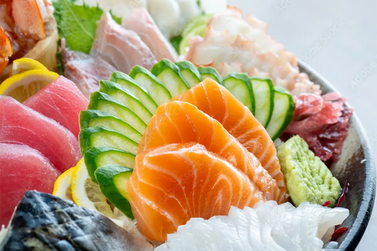 Assorted fresh sashimi including salmon, tuna, etc., arranged with cucumber, lemon and wasabi at Senro Sushi, a Sushi restaurant in San Ramon
